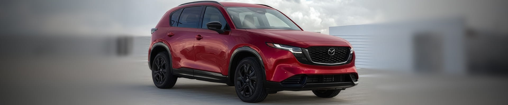Red Mazda SUV shown from the front three-quarter view.