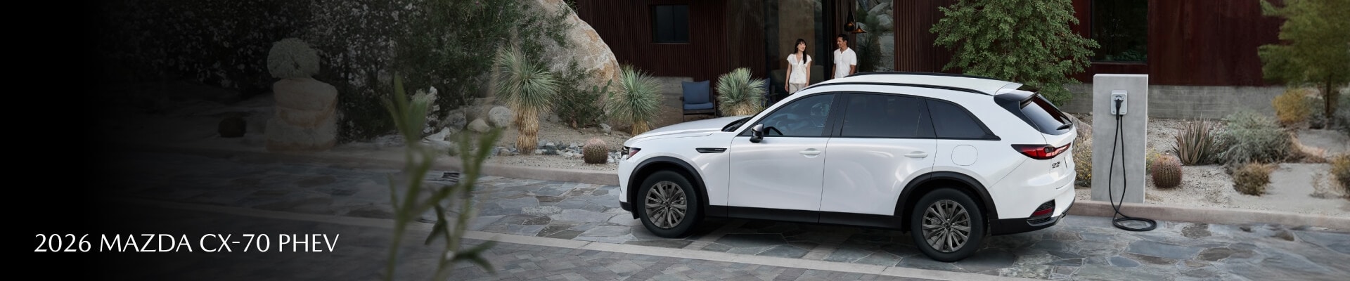 A 2026 Mazda CX-70 PHEV SC Plus in Rodium White Premium parked in an upscale driveway