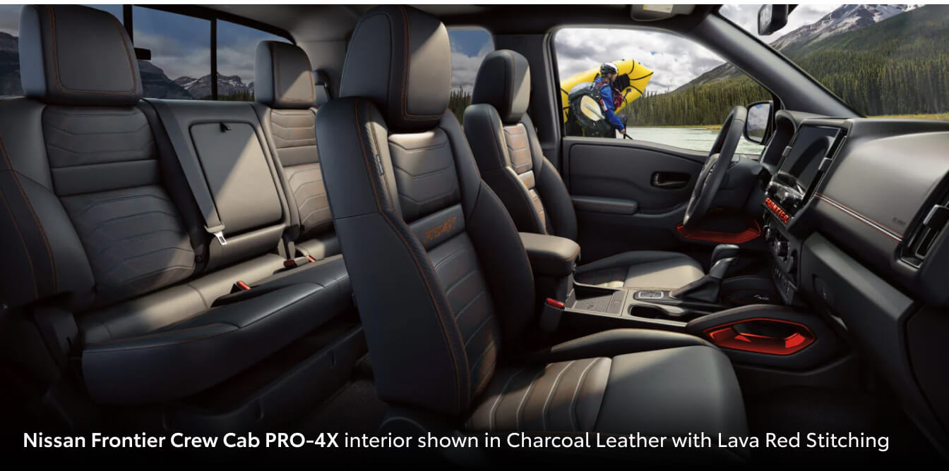 Interior view of a Nissan Frontier with Charcoal Leather and Lava Red Stitching