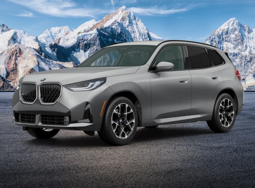 2025 BMW X3 30 xDrive parked in front of snowy New England mountain terrain
