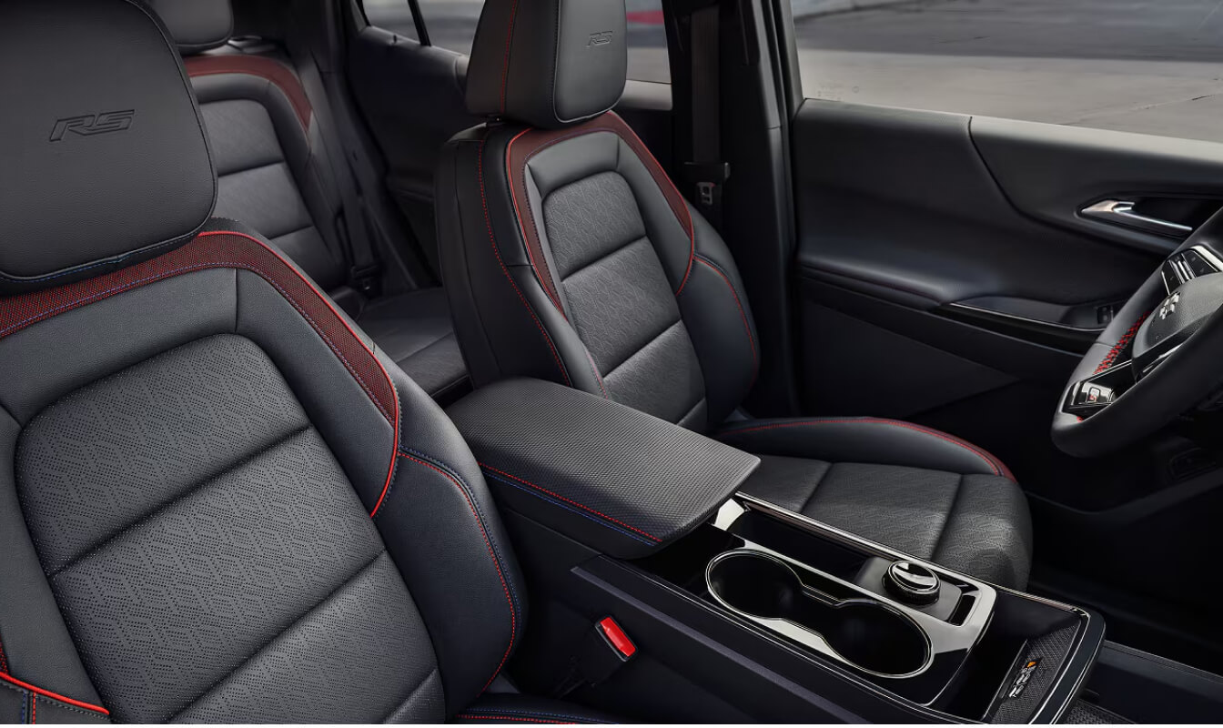 Interior view of front seats in a 2026 Chevrolet Equinox RS with Red stitching and Black Evotex upholstery.