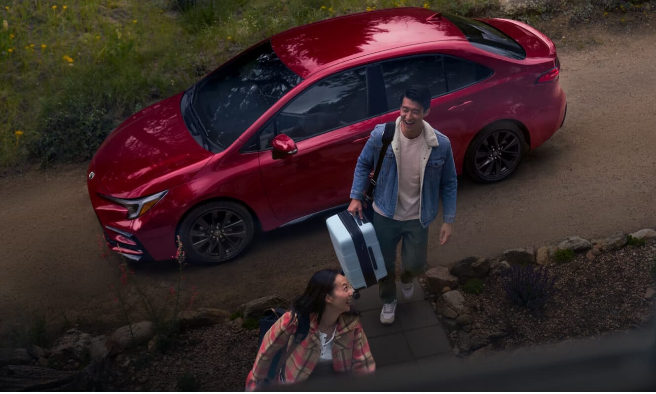 Two exterior angles of a 2026 Toyota Corolla SE in Ruby Flare Pearl