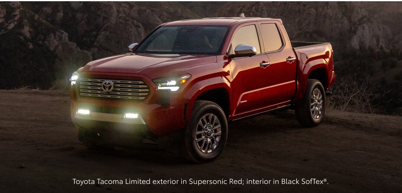 Three-quarter front view of a Supersonic Red Toyota Tacoma Limited with headlights.
