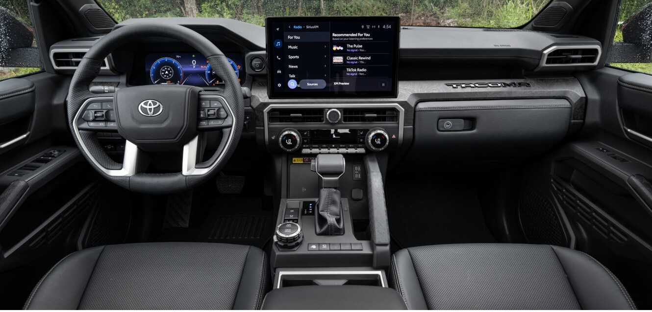 Interior dashboard view of a Toyota Tacoma Limited showing the digital gauge cluster.