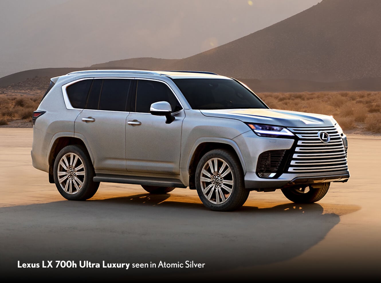 2026 Lexus LX 700h Ultra Luxury in Atomic Silver, front three-quarter view in a desert mountain setting.