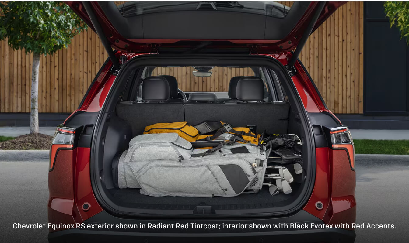 Rear cargo view of a 2026 Chevrolet Equinox RS in Radiant Red Tintcoat loaded with luggage.