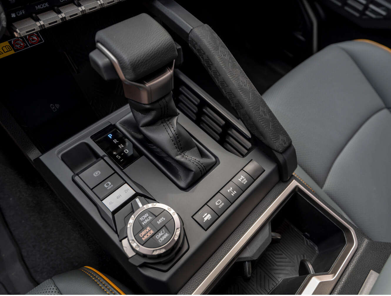 Close-up interior view of a Toyota Tacoma Trailhunter center console showcasing the gear shifter.