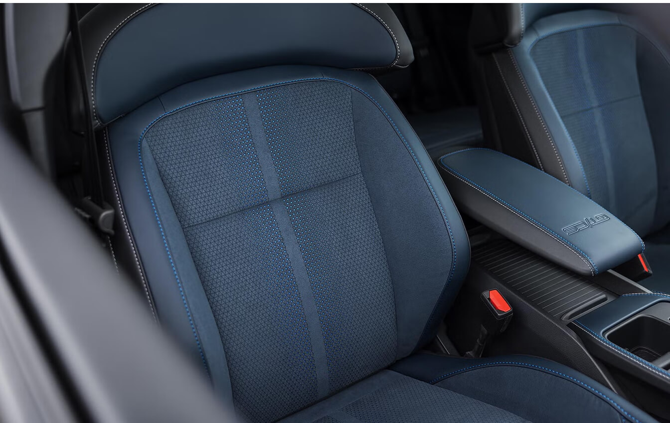 Close-up shot from outside passenger window showing Mustang Mach E upholstery details.
