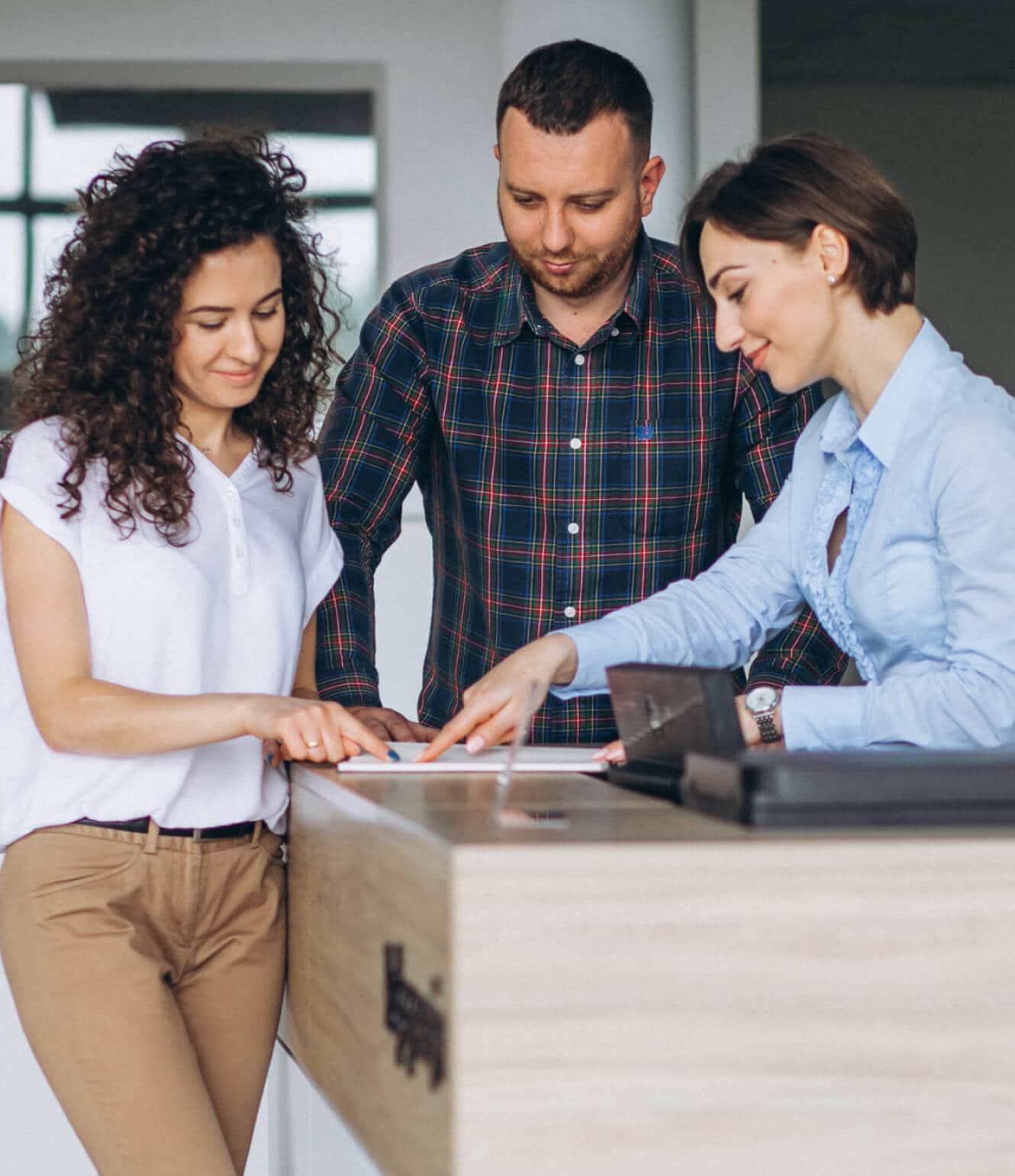 Customers looking over the new car paperwork at a McGee Dealership