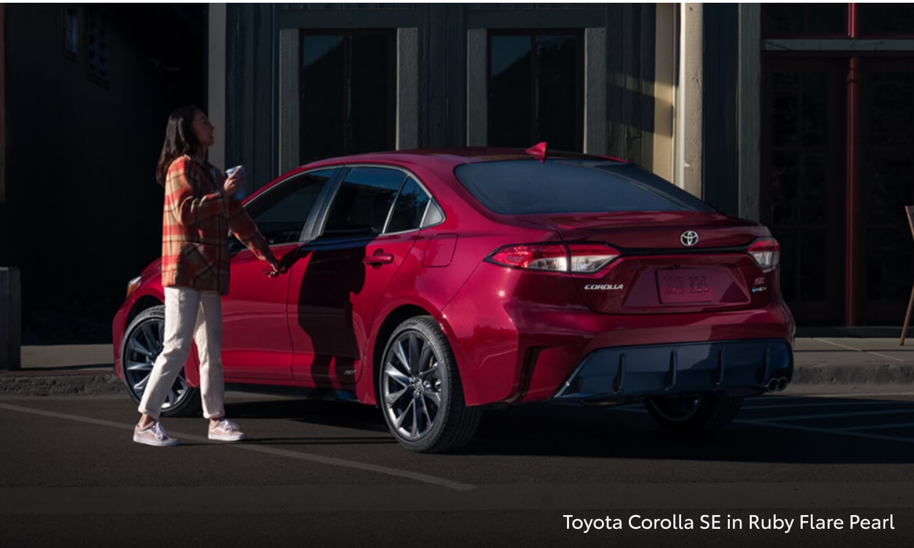 Two exterior angles of a 2026 Toyota Corolla SE in Ruby Flare Pearl