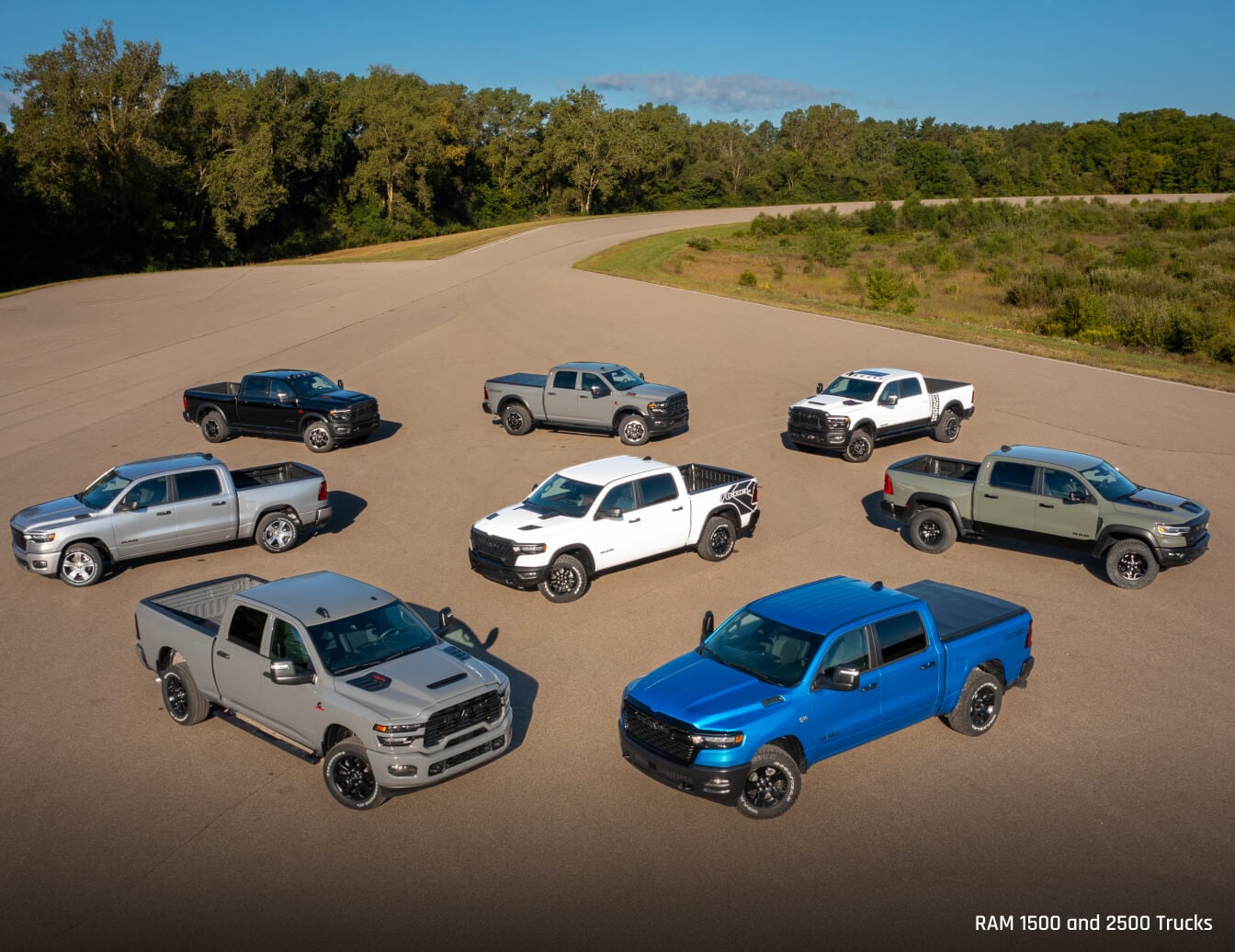 Eight 2026 Ram Trucks parked in a sandy lot