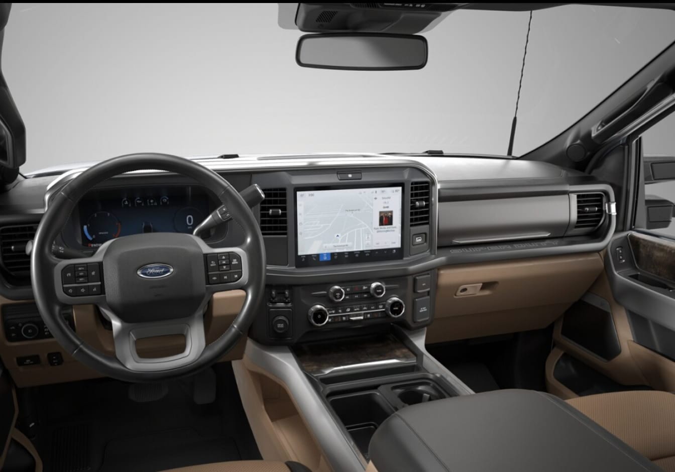 A driver’s view of the Ford Super Duty interior featuring a multifunction steering wheel, and a center touchscreen with navigation.