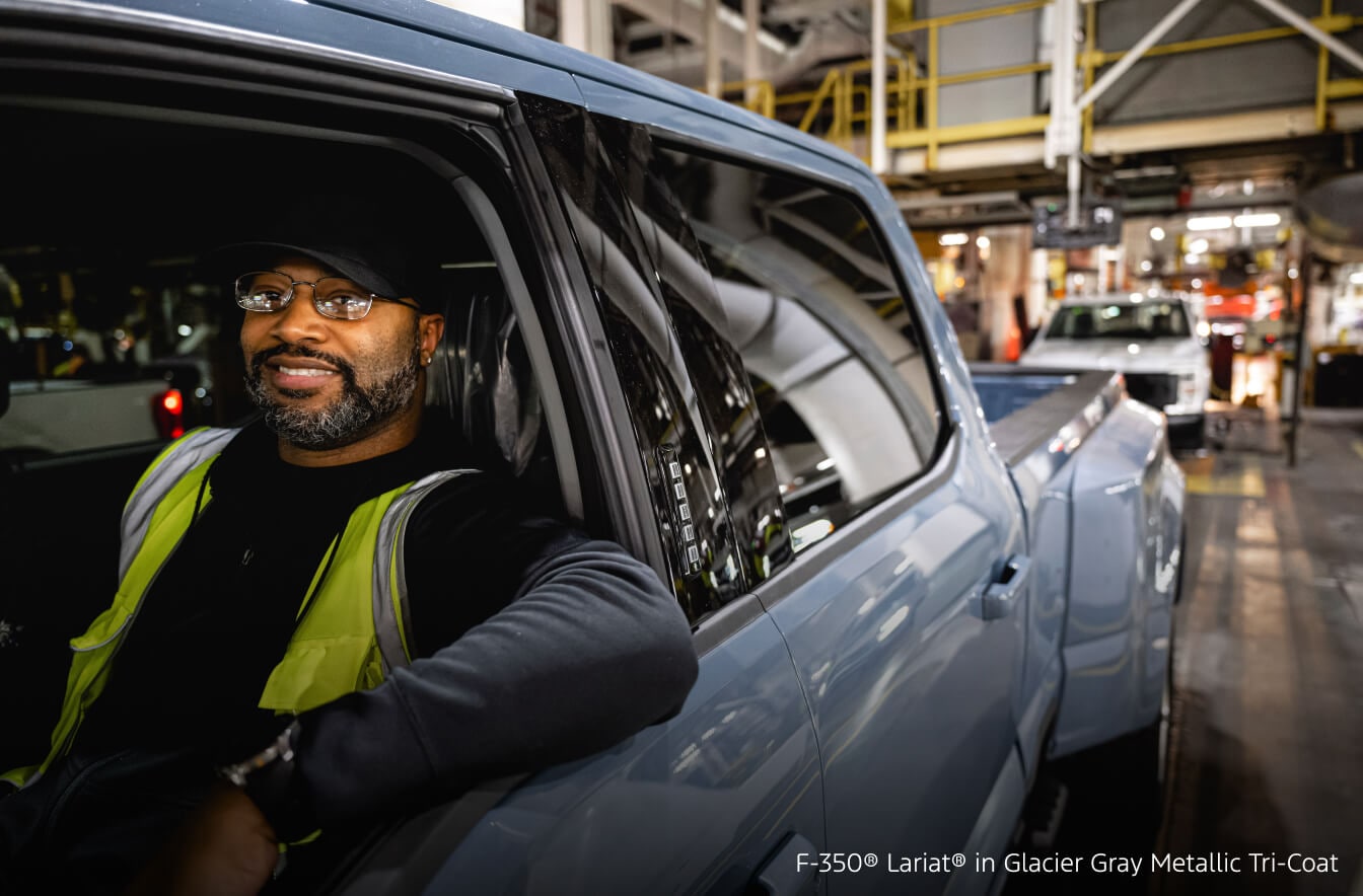 Construction worker driving a Ford Super Duty F-350 Lariat on a job site