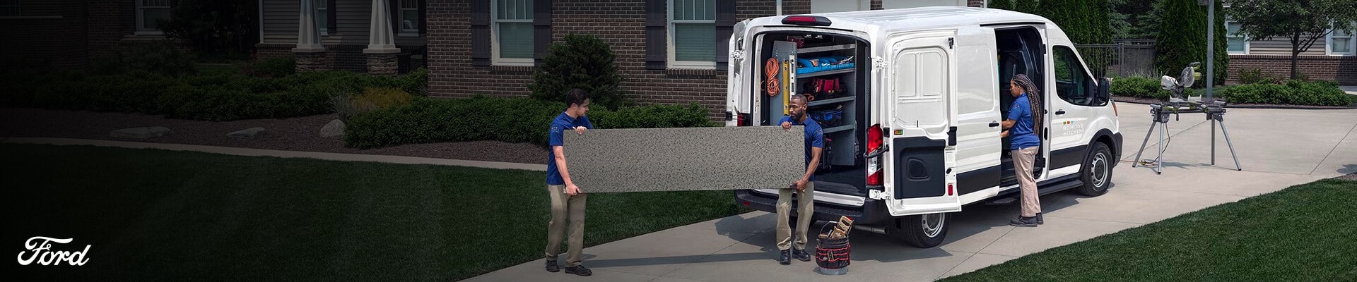 Three-quarter rear view of a 2027 Ford Transit Cargo Van in Oxford White parked on a residential driveway, showing contractors.