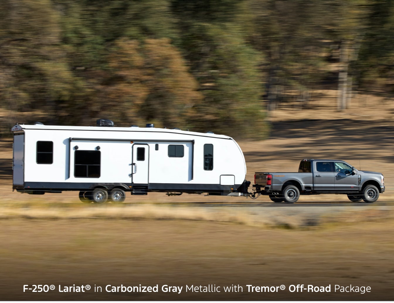 2026 Ford F-250 Lariat in Carbonized Gray towing an RV