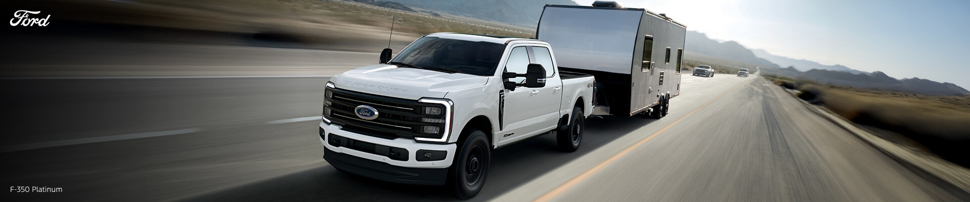 Ford F-350 Super Duty Platinum in White towing a trailer on the highway