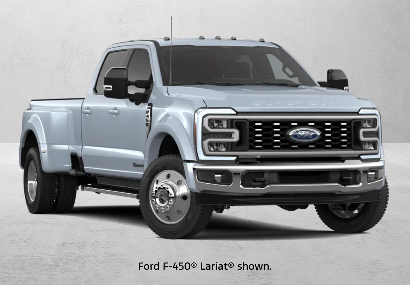 A light blue Ford F-450 Lariat pickup truck shown from a front three-quarter angle against a neutral gray background.