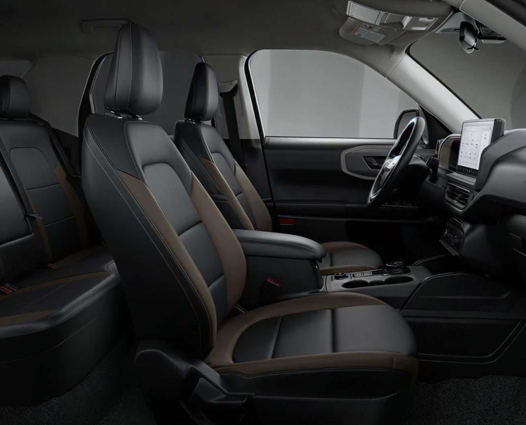 2026 Ford Bronco Sport interior showcasing sleek seats, a digital dashboard display, and a minimalist steering wheel, conveying luxury and comfort.