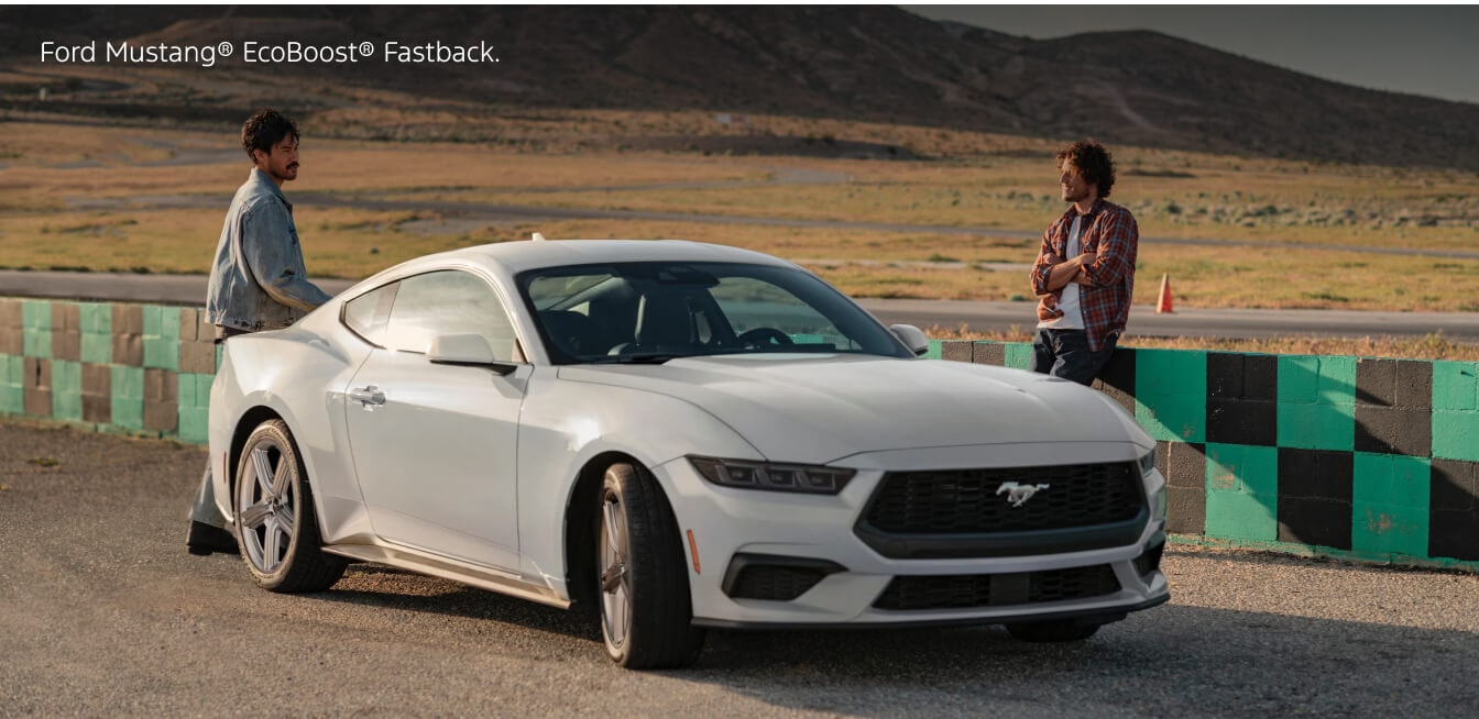 Front three-quarter view of a 2026 White Ford Mustang EcoBoost Fastback parked at a racetrack.