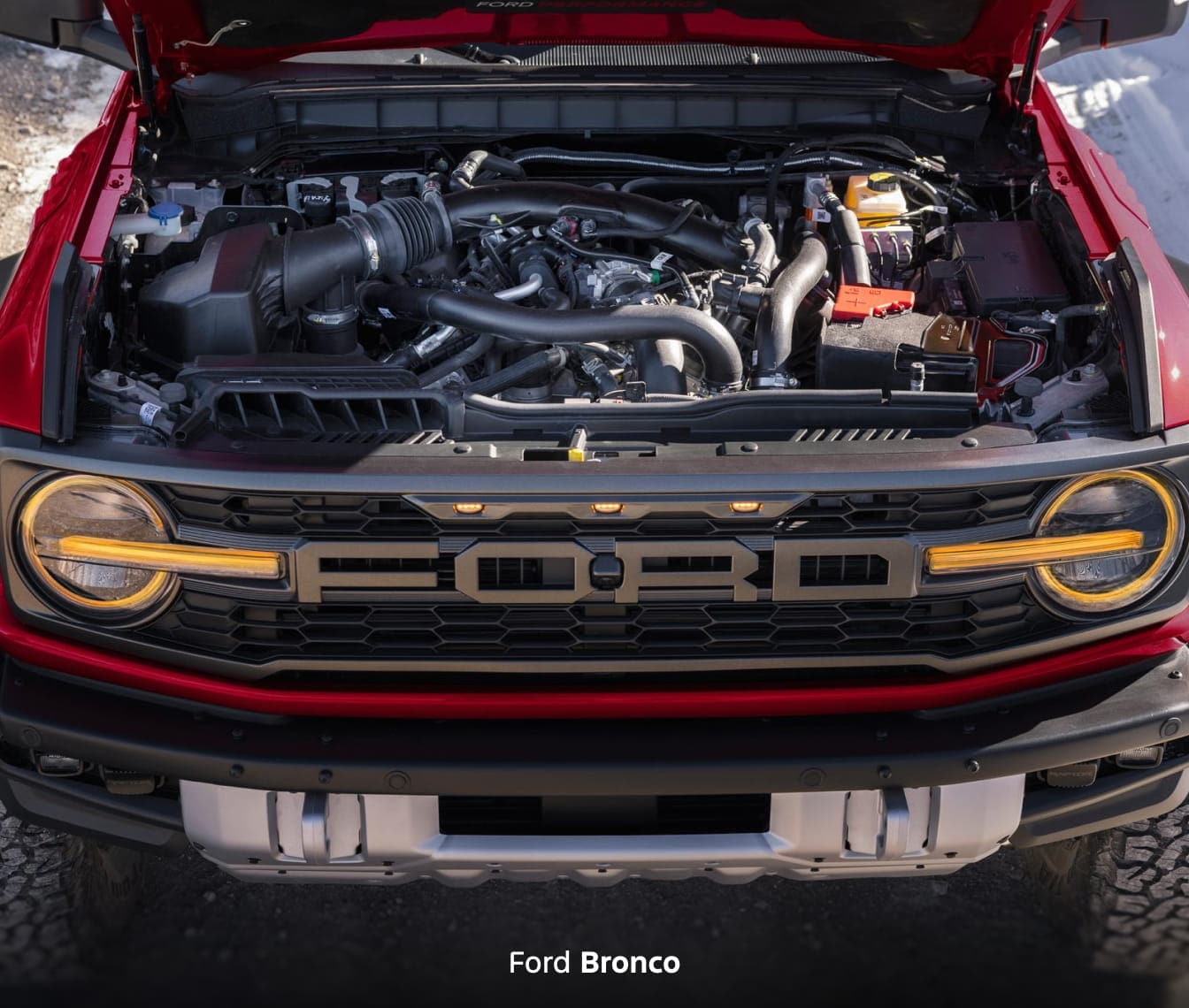 The engine bay of a red 2026 Ford Bronco.