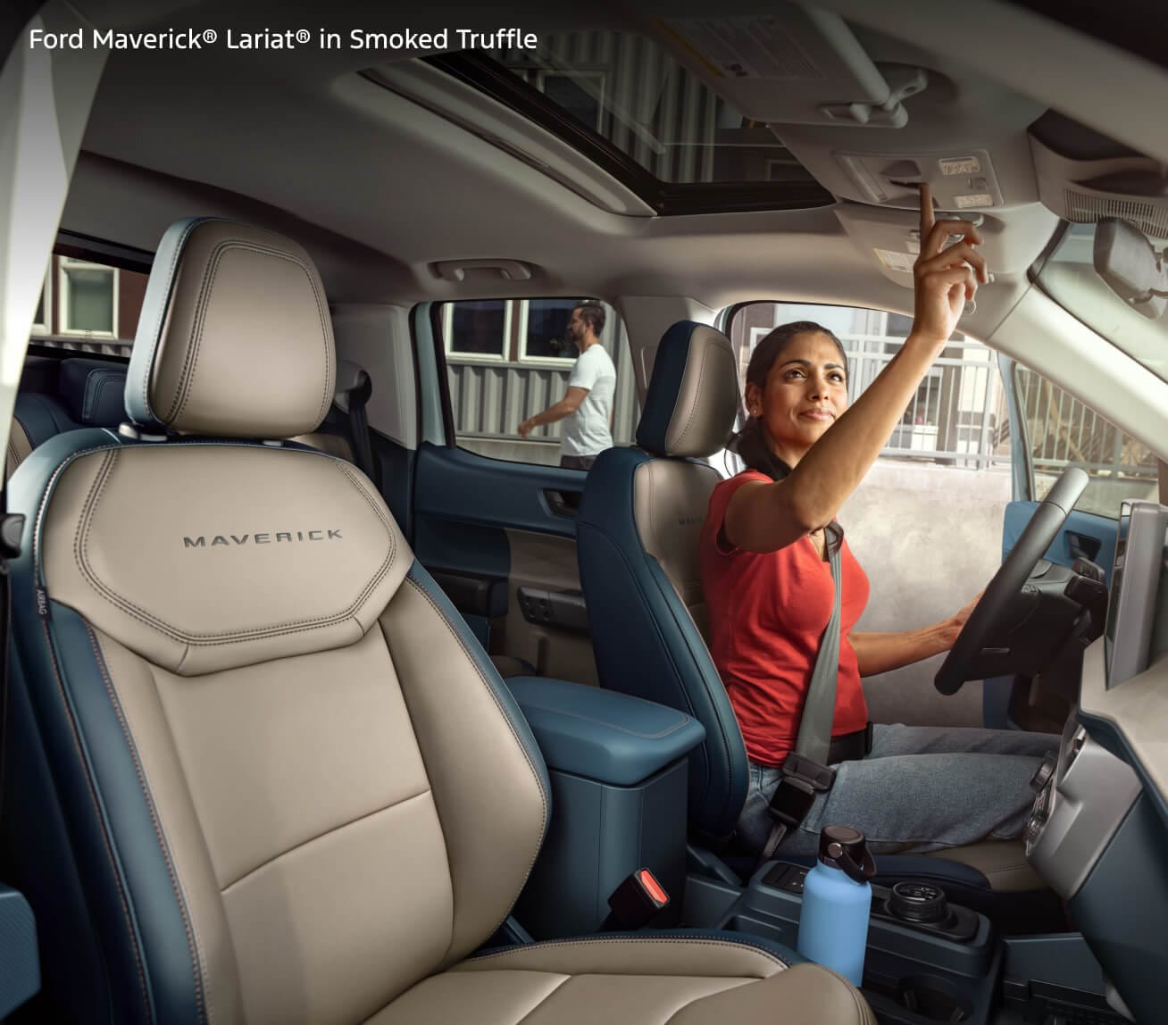 A woman in the driver's seat of a 2026 Ford Maverick