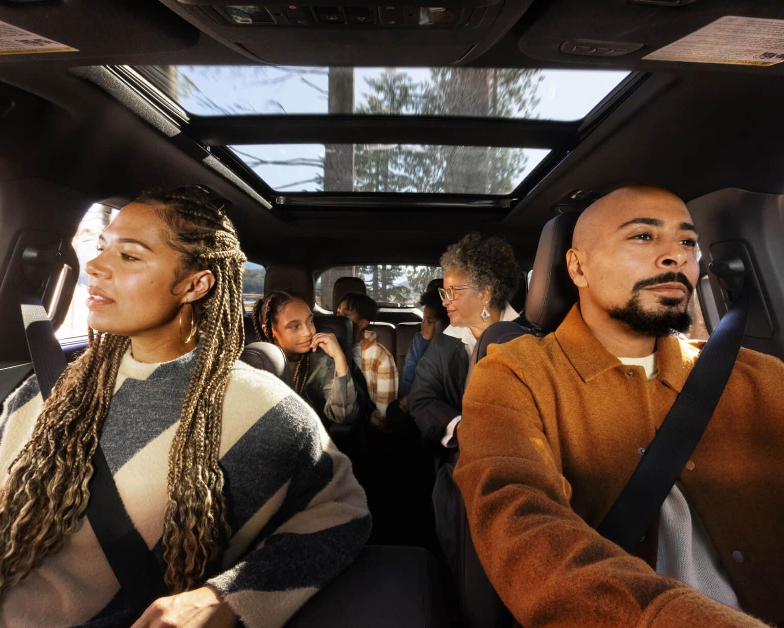 A family of 6 sitting in three rows of seats inside of a 2026 Ford Explorer Platinum