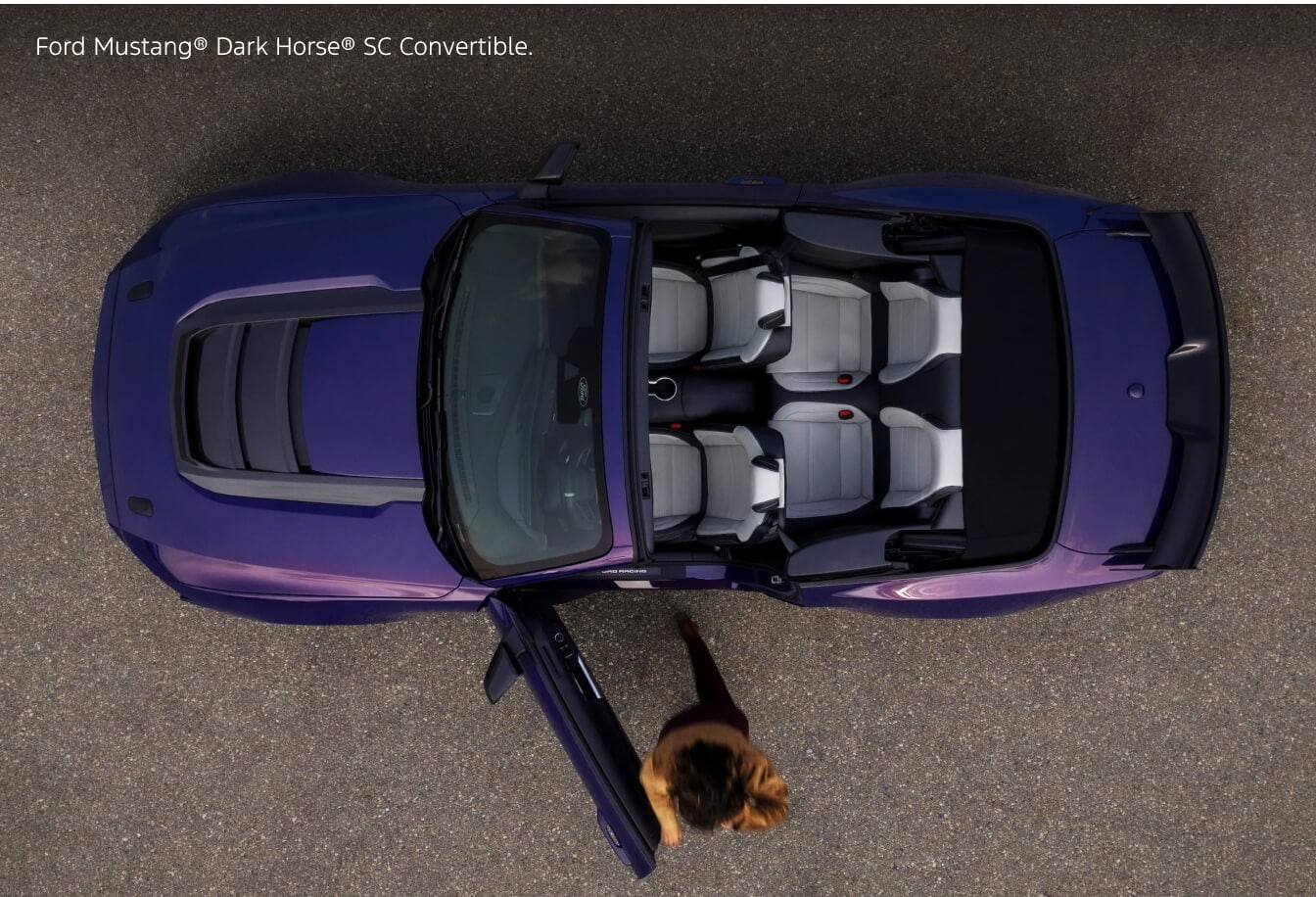 Overhead aerial view of a 2026 Purple Ford Mustang Dark Horse SC Convertible with driver door open.