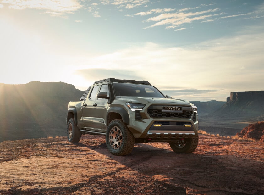 2025 Toyota Tacoma Hybrid Trailhunter in Bronze Oxide parked over wet and muddy terrain
