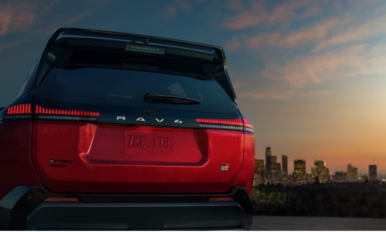 Rear close-up view of a Supersonic Red Toyota RAV4 Plug-In Hybrid GR Sport showing PHEV AWD badging.