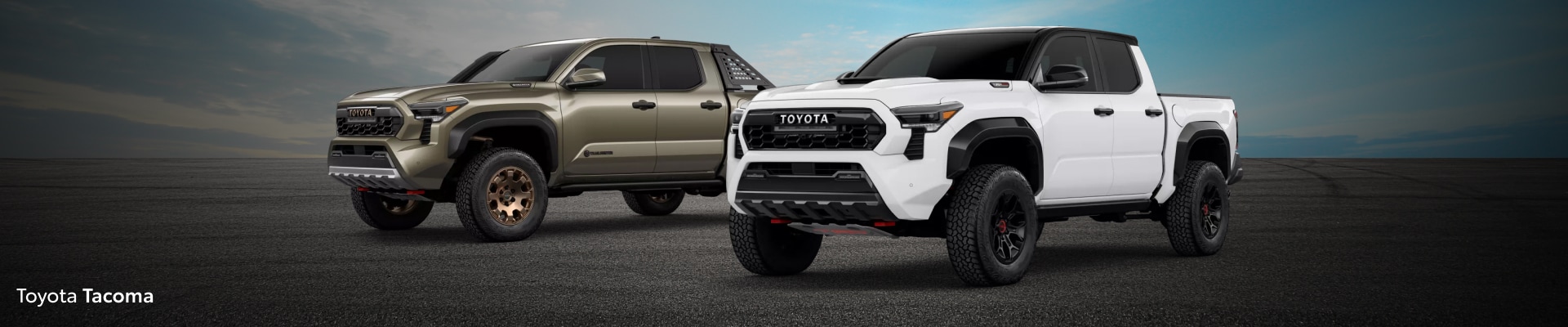 Two 2026 Toyota Tacoma Trucks: Trailhunter Trim in Bronze Oxide on left and TRD Pro in Ice Cap on Right