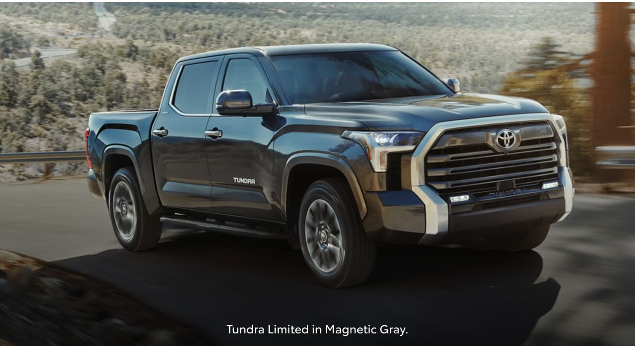 Front three-quarter view of a gray Toyota Tundra Limited driving on a mountain road.