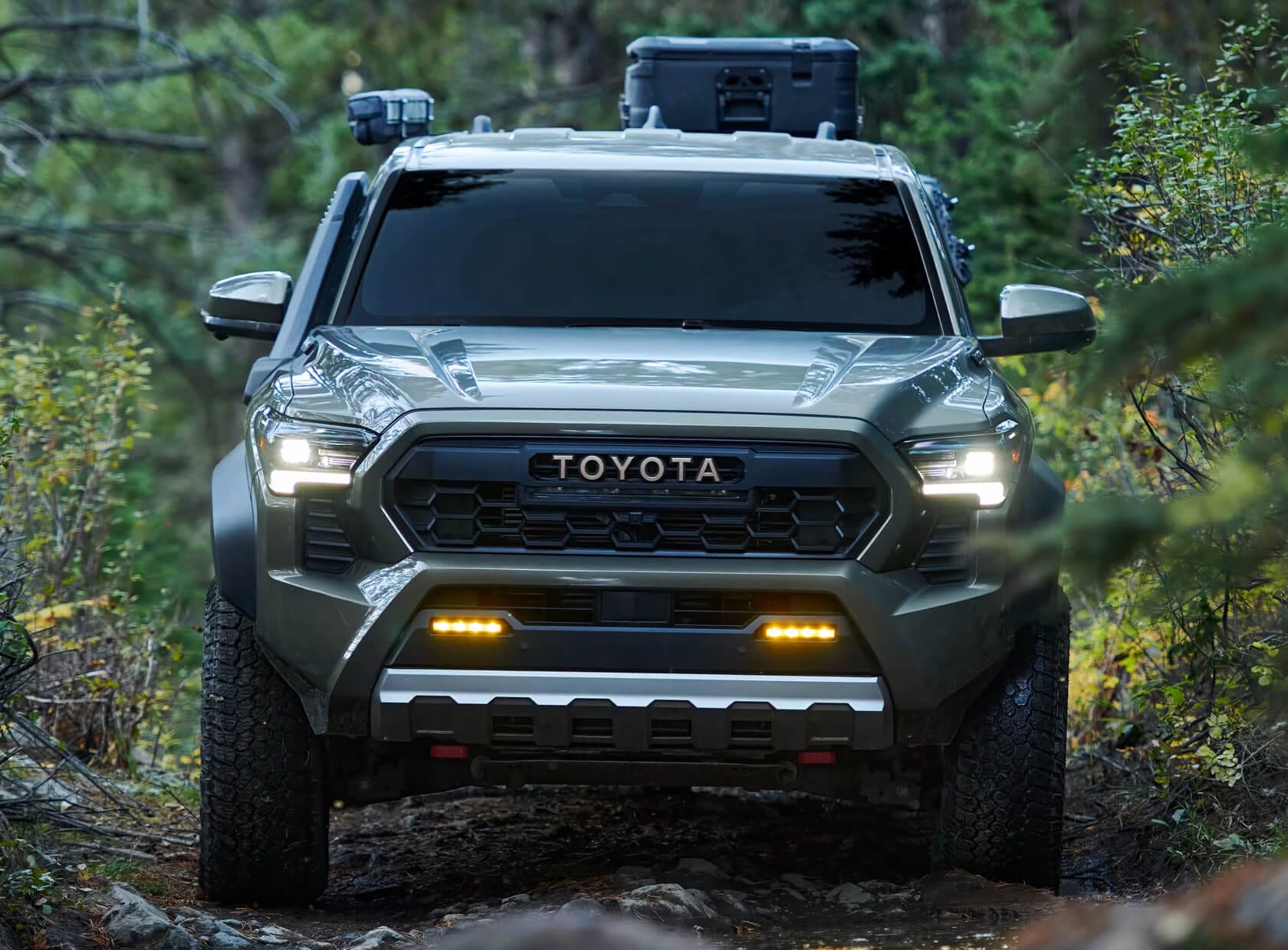 Toyota Tacoma Trailhunter in Bronze Oxide driving in the forest