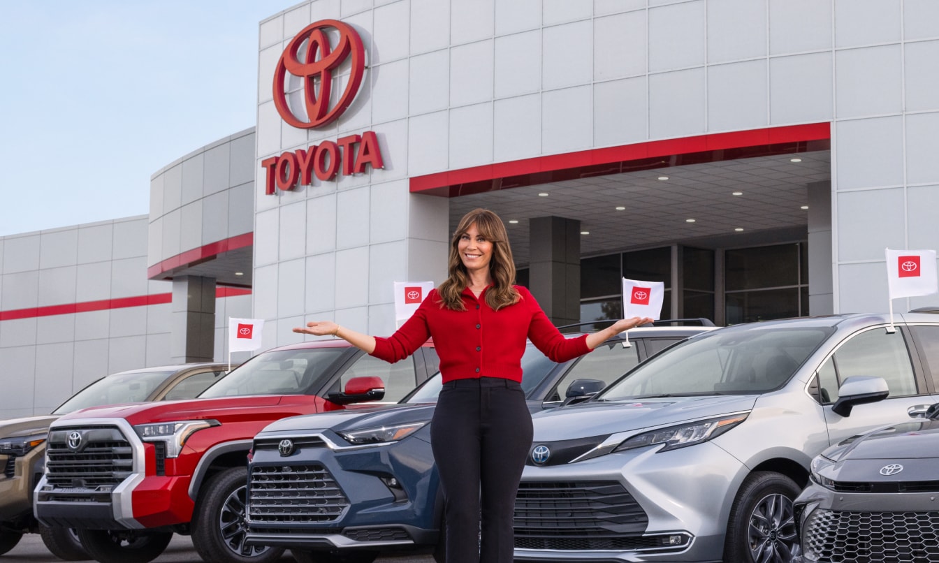 New Toyota Cars, Trucks & SUVs for rent parked outside of a Toyota Dealership in Massachusetts