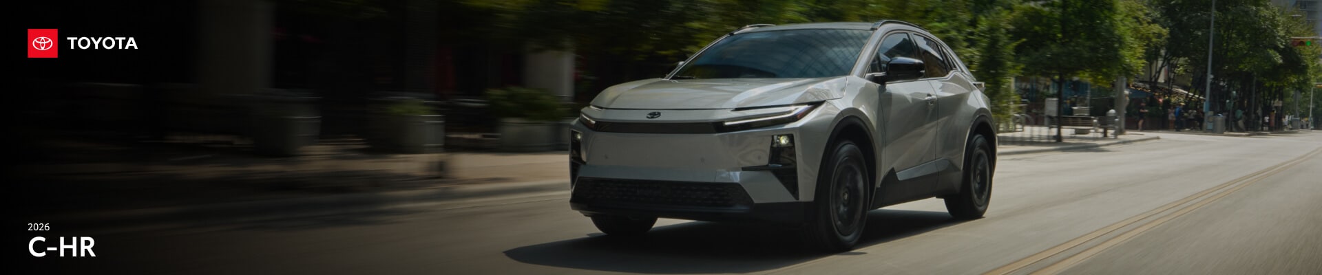 2026 Toyota C-HR SE in Cement driving past a city park