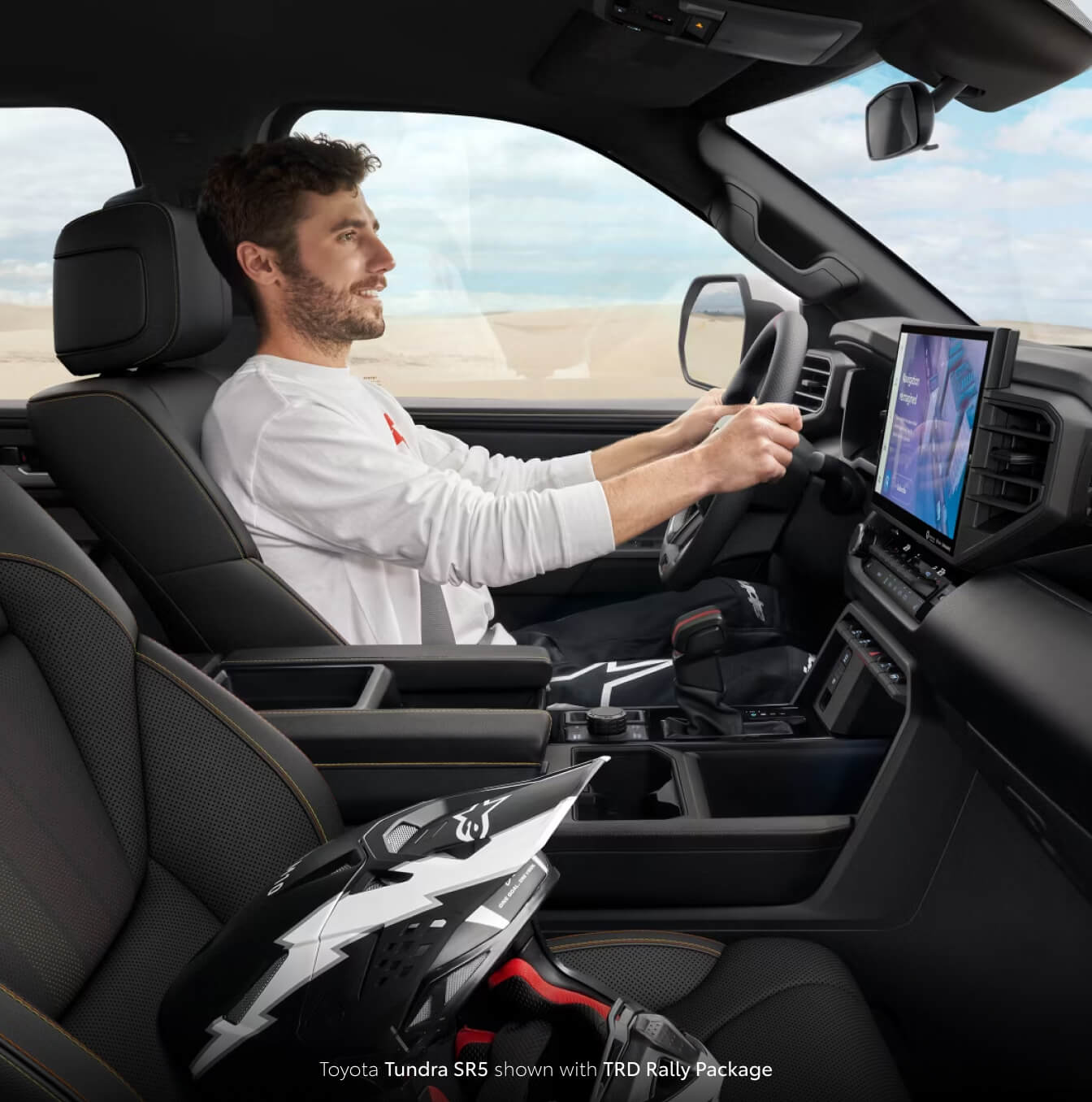 Male driver inside of a brand new 2025 Toyota Tundra SR5 with black interior