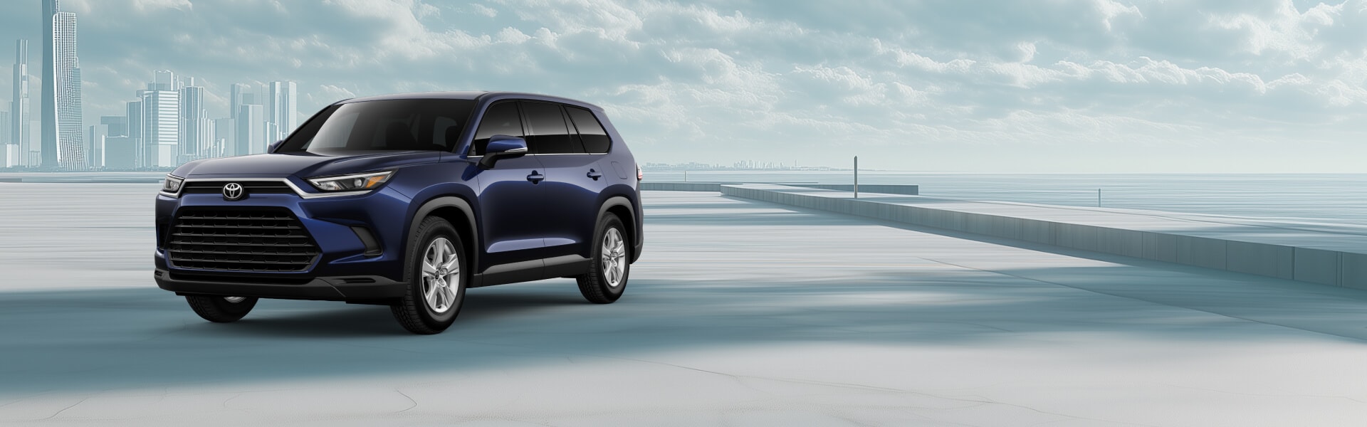 2026 Toyota Grand Highlander Hybrid in Dark Blue with a cloudy cityscape background