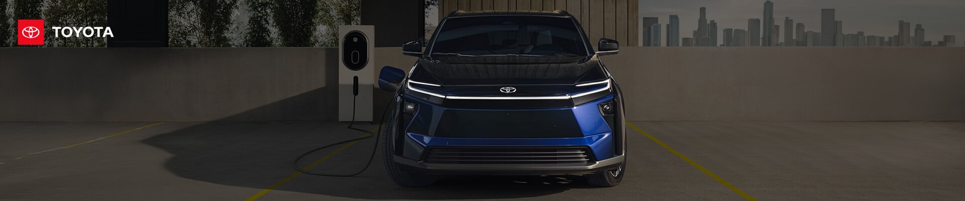 2026 Toyota bZ Limited in Blueprint charging atop a parking garage