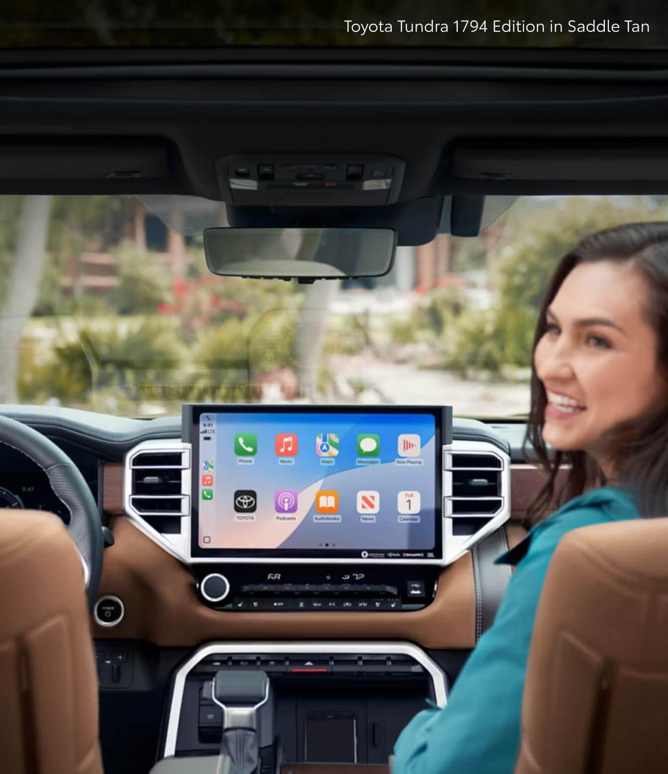 Woman and large touchscreen in the front seat of a 2026 Toyota Tundra 1794 Edition