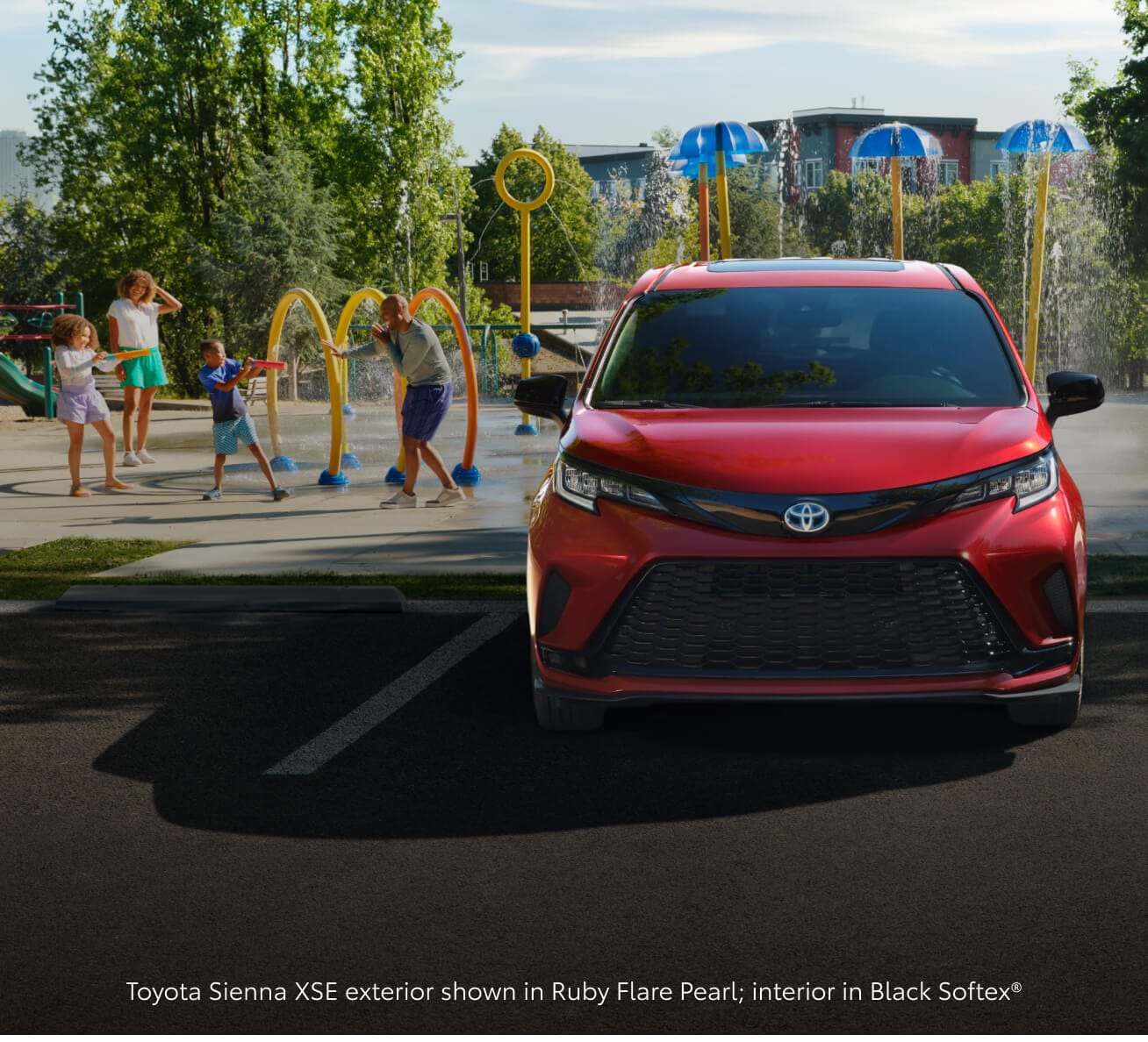 Toyota Sienna XSE in Ruby Flare Pearl parked at a playground