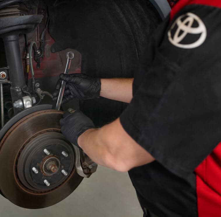  Toyota Technician working on brakes