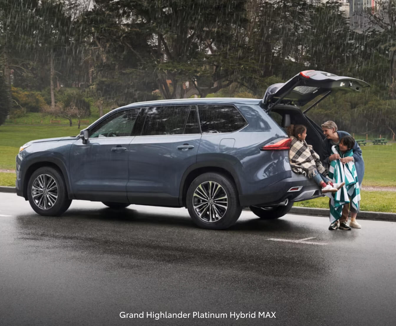 A family under the liftgate of their 2026 Toyota Grand Highlander