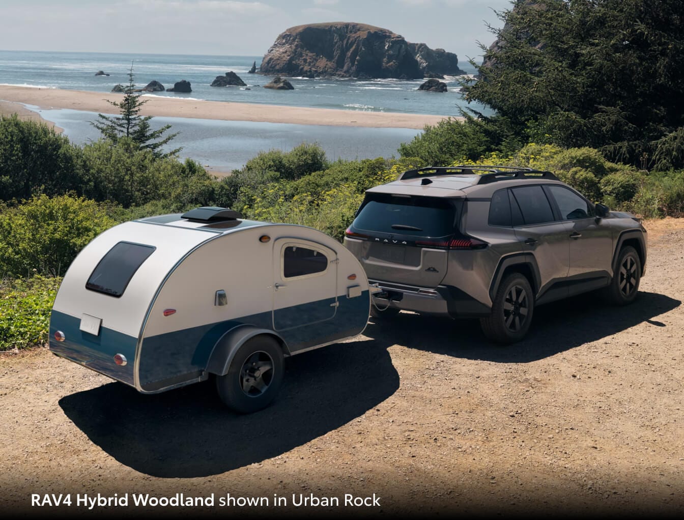 2026 Toyota RAV4 Hybrid towing a small trailer along a beach cove