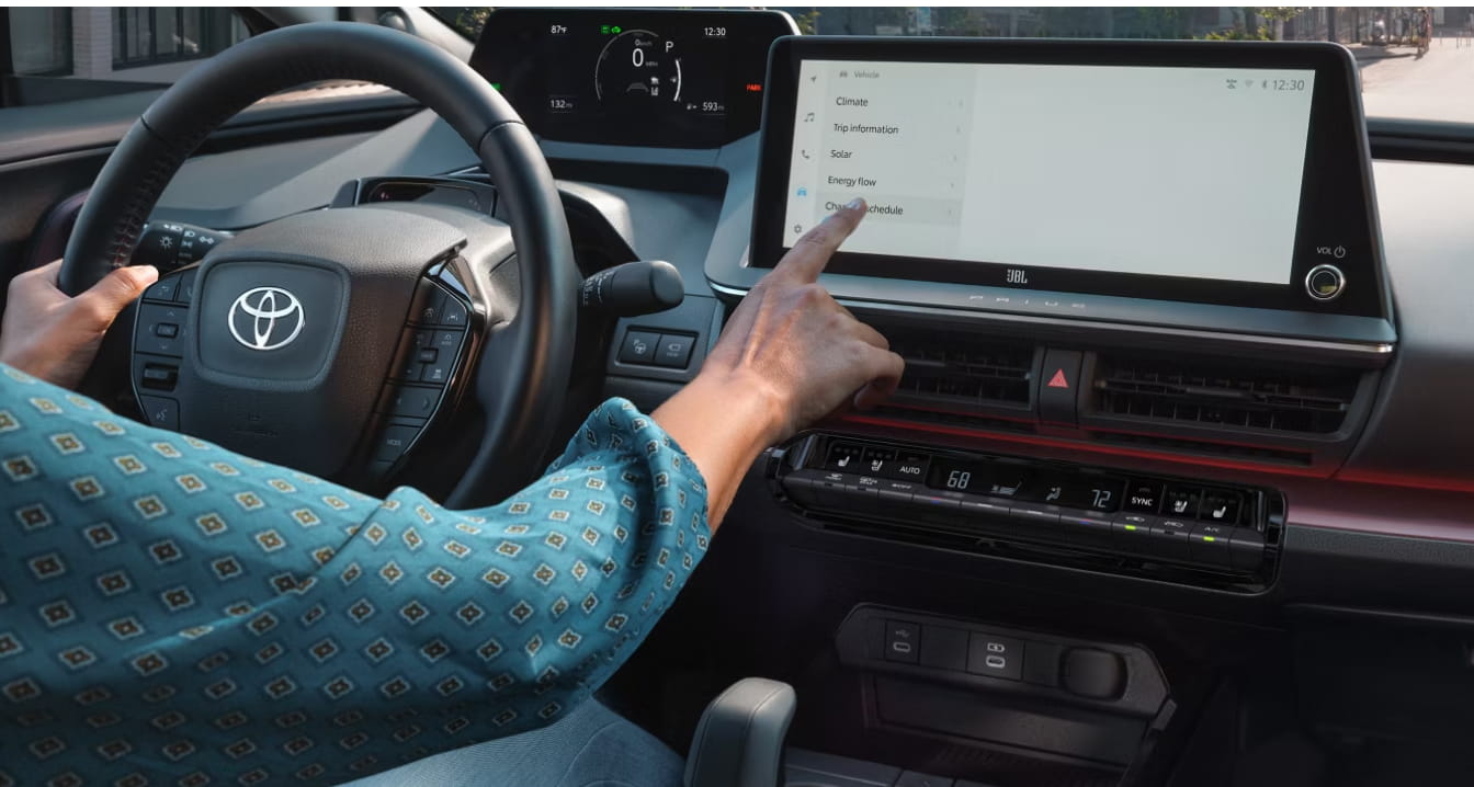 2026 Toyota Prius interior featuring a digital instrument display and large touchscreen infotainment system.