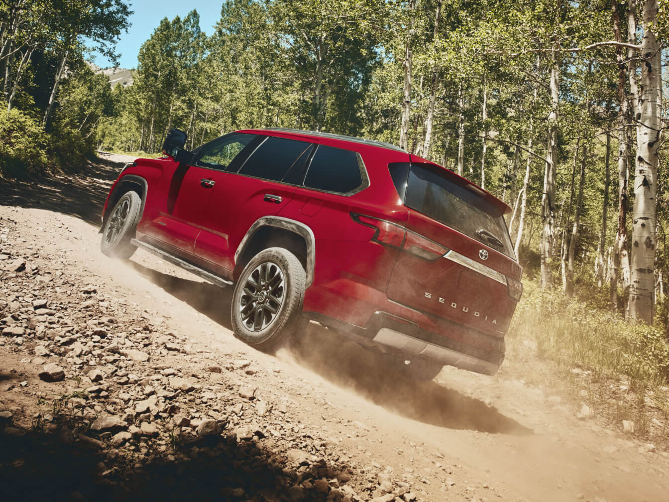 2026 Toyota Sequoia Limited in Supersonic Red kicking up dirt on off-road terrain