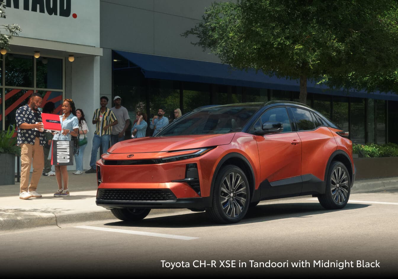 2026 Toyota CH-R in Tandoori parked outside of a store