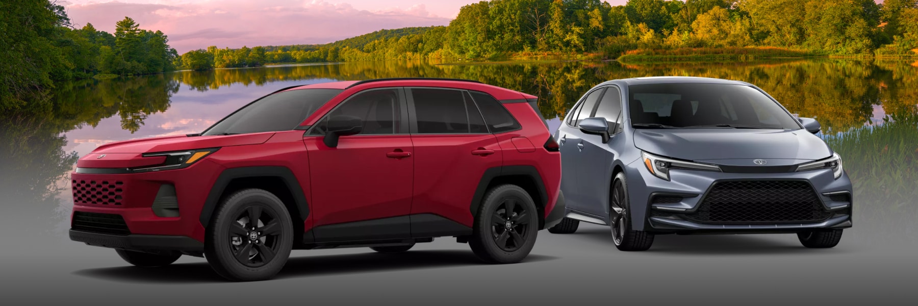 2026 Toyota RAV4 in red & Corolla in Silver parked in front of a lake