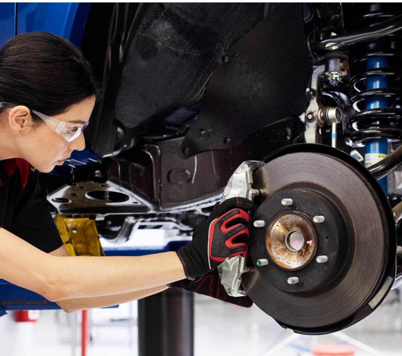 Toyota Tacoma TRD Off-Road brake assembly components on garage lift.