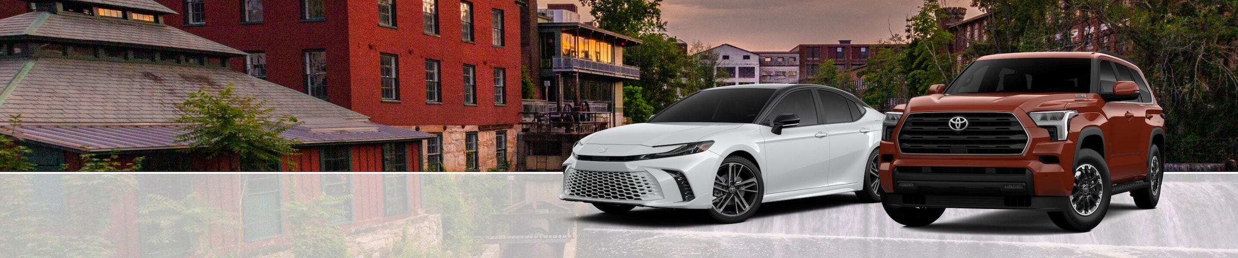 Toyota Avalon Sedan and Toyota Tundra Truck parked in front of an urban background