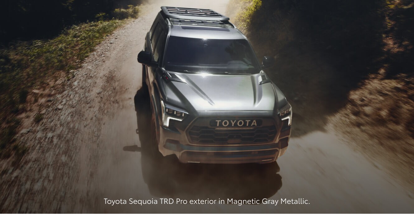 High-angle front view of a 2026 Gray Toyota Sequoia TRD Pro speeding along a dusty mountain.