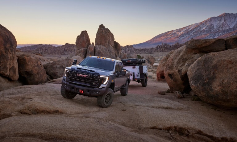 2025 GMC Sierra 2500 HD Exterior On Rocks With A Camper